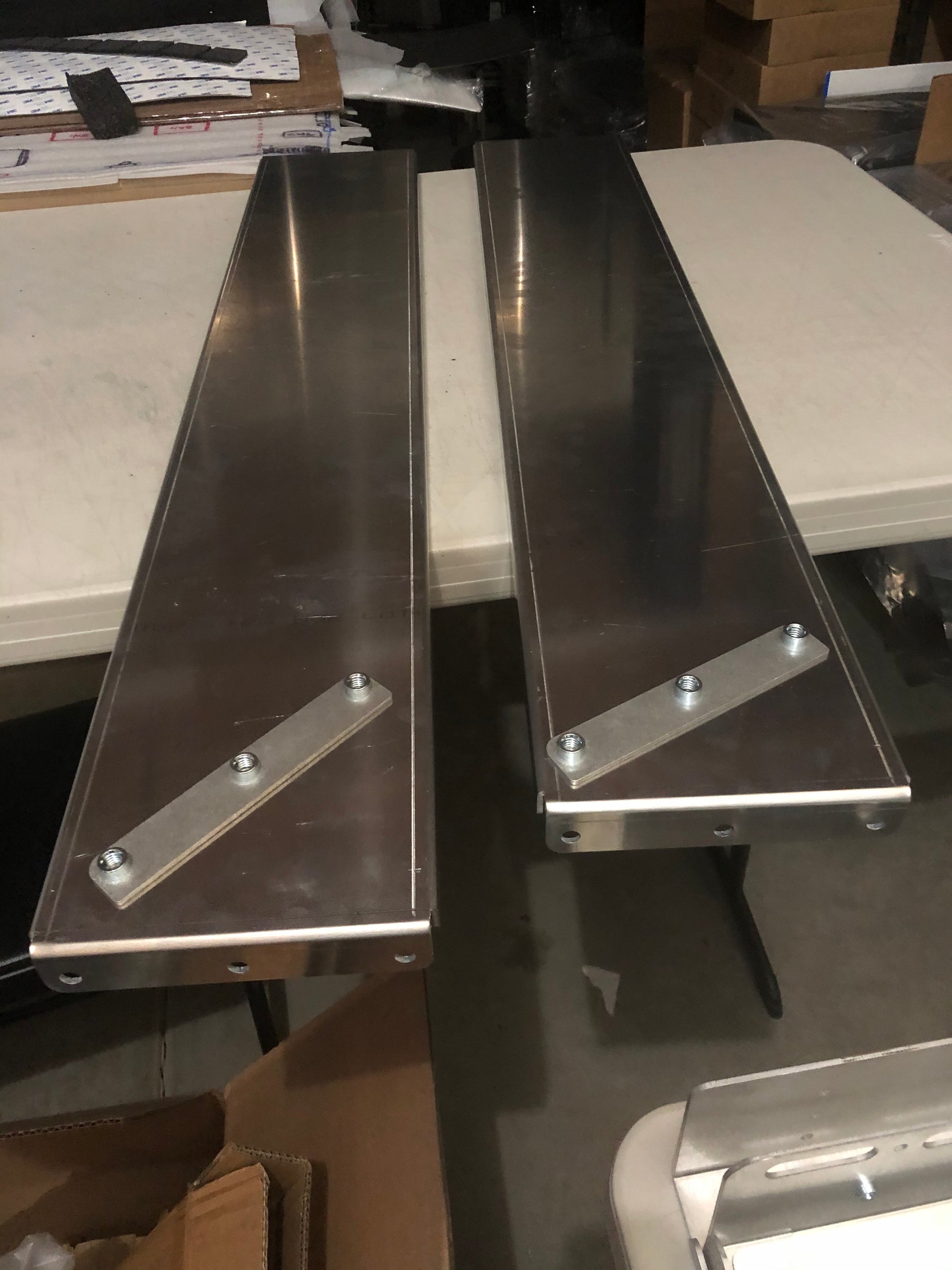 Product photo of the Rail Rack Accessory mount shelf in raw aluminum prior to painting or finishing. 
