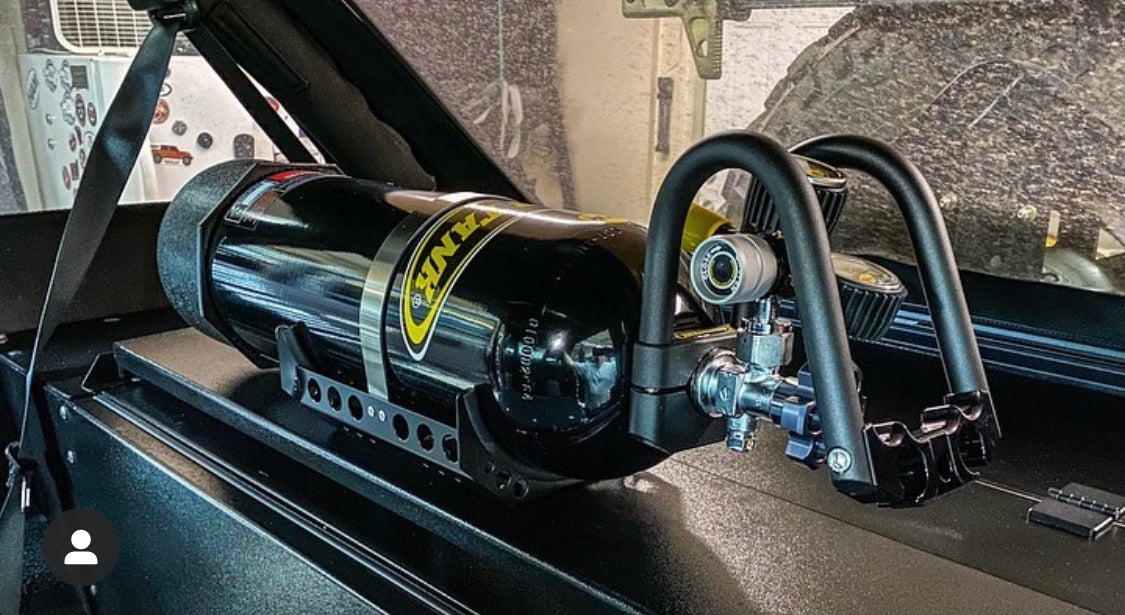 Image of a Diabolical, Inc. Rail Rack installed in a Jeep Wrangler showing a PowerTank compressor mounted on the accessory Rail Rack.