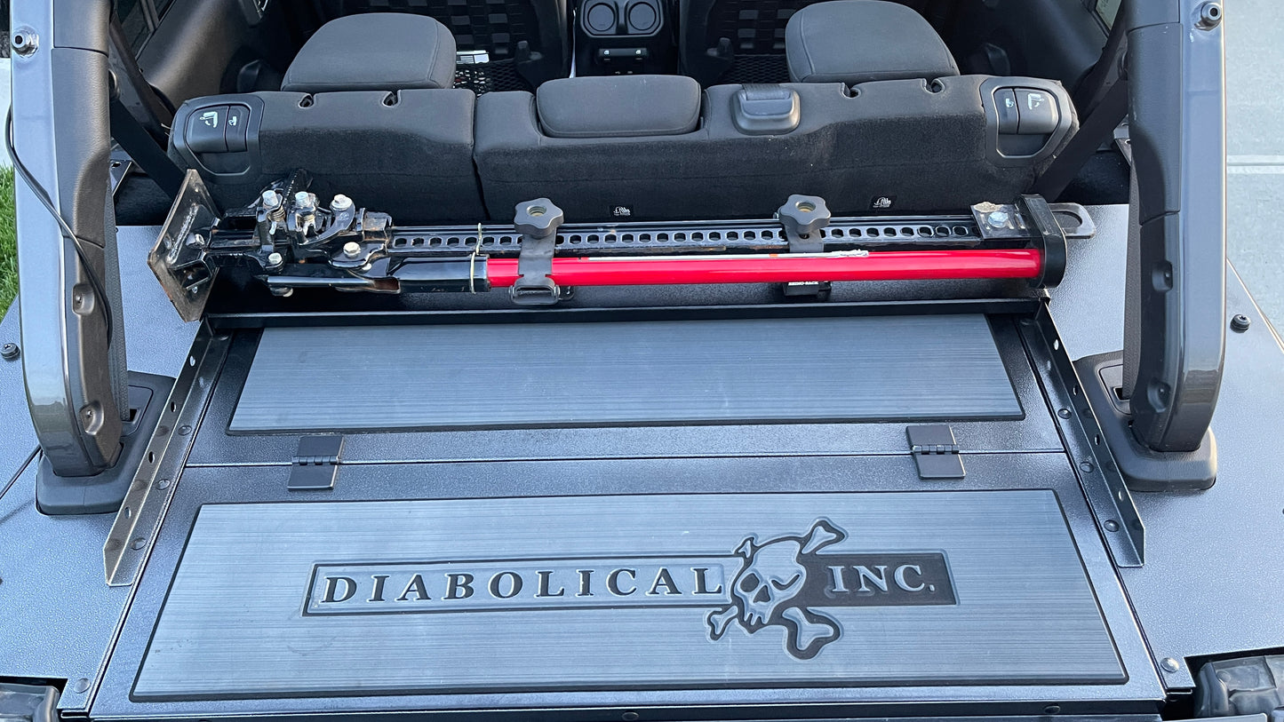 Image of a Jeep Wrangler JKU with a Diabolical, Inc. Slipstream security enclosure and foam deck pads with the Rail Rack accessory mount installed with a HiLift Jack.