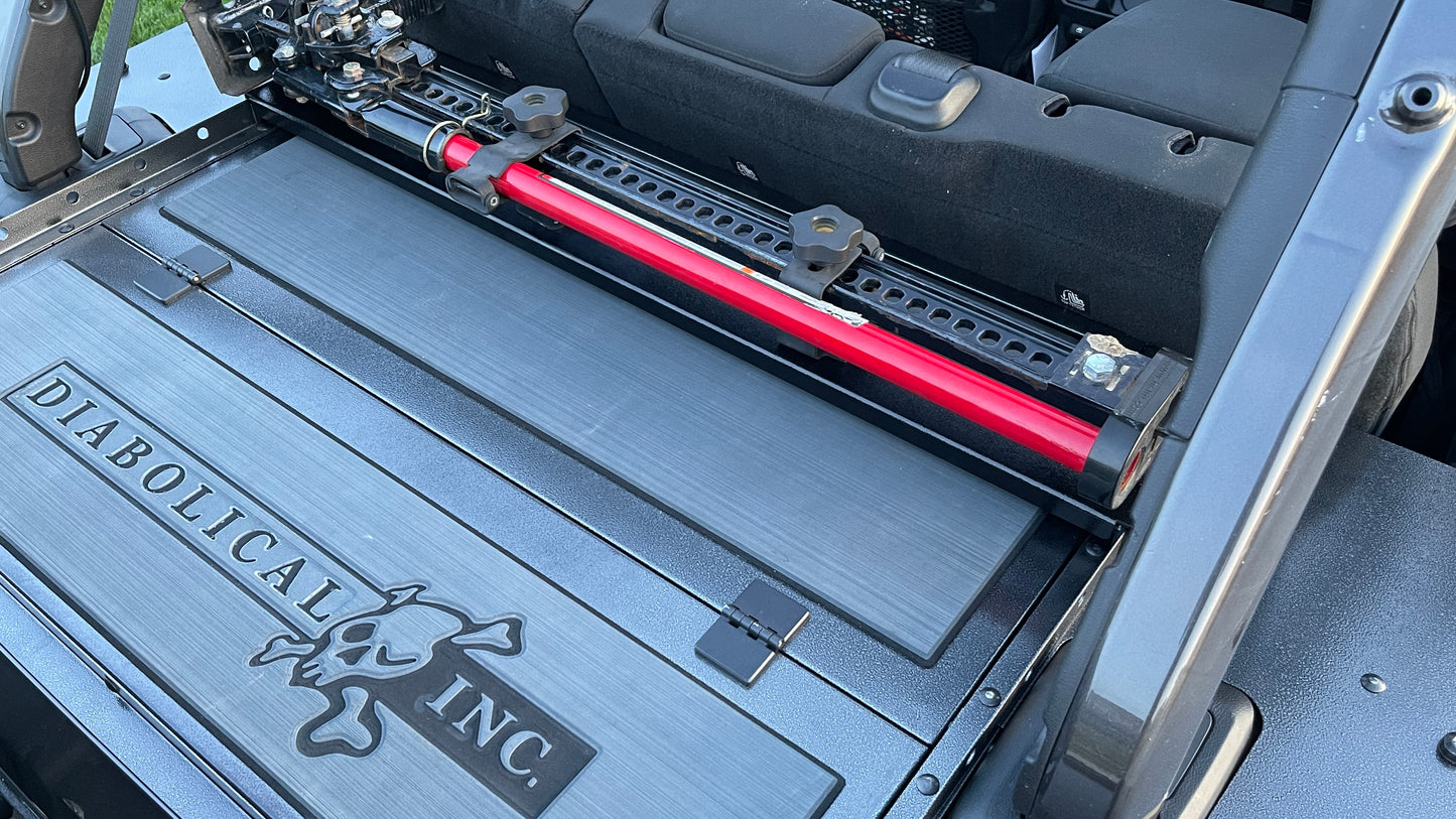 Image of a Jeep Wrangler JKU with a Diabolical, Inc. Slipstream security enclosure and foam deck pads with the Rail Rack accessory mount installed with a HiLift Jack.